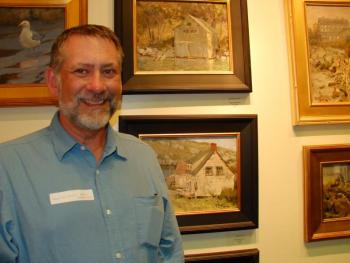 Roger Dale Brown of Nashville poses near some of his paintings.