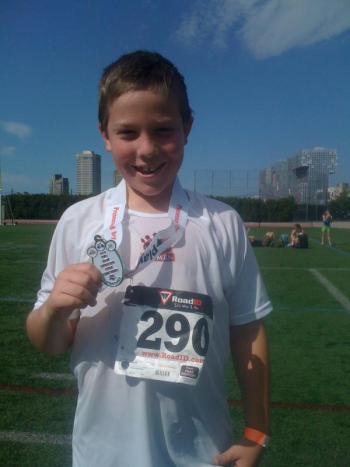 Adam is all smiles after receiving his medal.